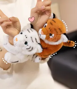 Detail of plush tiger slap bracelets in white and orange with embroidered facial features