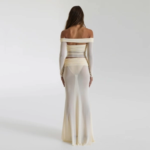 Detail view of sheer beige mesh set showing off-the-shoulder top and long skirt back