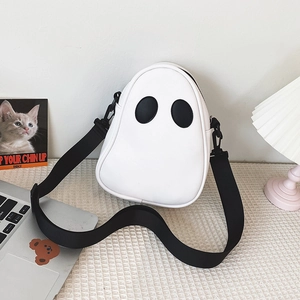Close-up of white ghost shaped PU leather crossbody bag with cartoon eyes and nylon strap