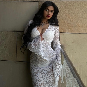 Elegant white lace V-neck maxi dress with long flare sleeves shown on a model outdoors