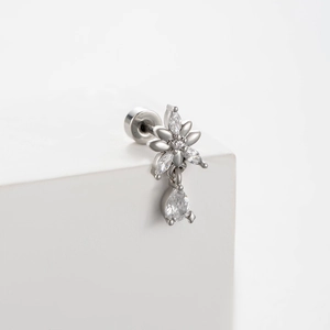 Silver flower and teardrop stud earring with sparkling cubic zirconia on white background