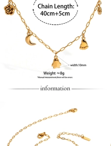 Detail of gold stainless steel necklace featuring rose, moon, and penguin charms