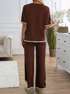 Rear view of brown knitted two-piece lounge set with white trim on top and wide pants