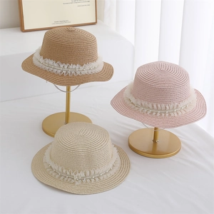Three elegant straw hats with white lace trim and pearl strings in khaki pink and beige
