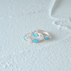 Macro shot of S925 silver turquoise hoop earrings with marquise-cut stones and zircons