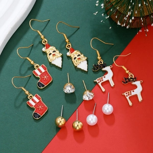 Close-up of 6 pairs Christmas earring set featuring Santa, reindeer, and festive beads