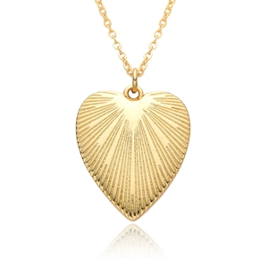 Detailed view of the heart-shaped gold pendant featuring radial textured patterns