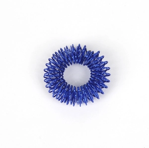 Macro detail of a blue metallic spring finger massage ring for stress relief therapy