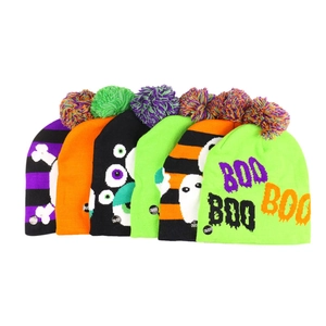 Macro detail of Halloween knit hats with LED lights, pumpkins, and spooky ghost patterns