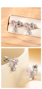 Detail of silver bow earrings featuring pink heart zirconia and secure screw backings