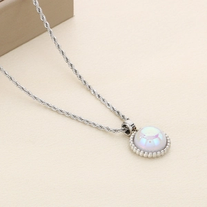 Macro detail of silver twisted rope chain necklace with iridescent pearl inlay pendant
