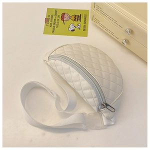 Detail of quilted diamond pattern on cream kids waist bag with metal zipper and strap