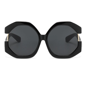 Oversized black cat-eye sunglasses with gold metal accents and geometric frames