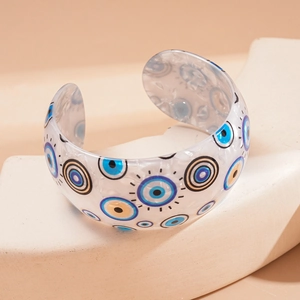 Minimalist iridescent acrylic open bangle featuring a geometric blue eye print detail
