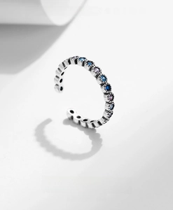 Macro detail of vintage 925 silver adjustable ring with gradient blue cubic zirconia