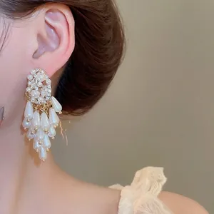 Elegant pearl and crystal fringe earrings featuring gold base and French vintage style