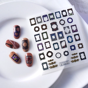 Detailed macro view of 5D embossed retro floral photo frame nail art stickers on a plate