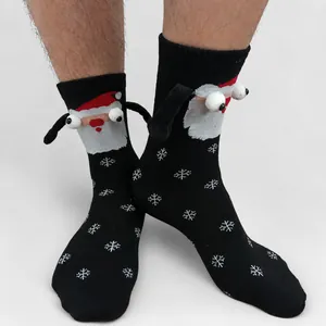 Detail of 3D Santa Claus socks with googly eyes and snowflake patterns for Christmas