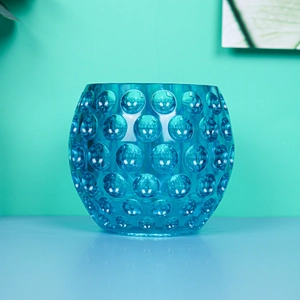 Detail of teal resin mold showing round bubble relief and transparent spherical texture