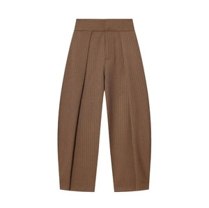 Detail of high waisted brown pinstripe balloon pants with pleated waist and wide leg cut