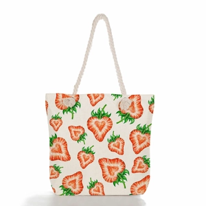 Close-up of strawberry print canvas tote bag with thick white woven rope handles