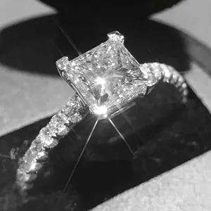 Elegant princess cut square diamond ring with pavé side stones in silver band
