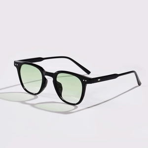 Classic round rivet sunglasses with black frame and light green lenses in 45-degree view