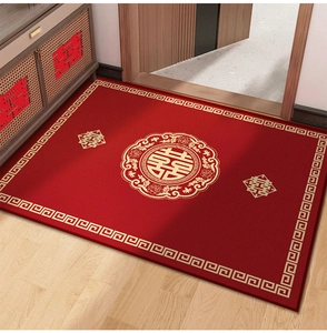Close-up of red wedding carpet with golden Xi character on a wooden floor
