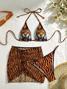 Three-piece bikini set with tiger head print top, striped bottoms and mesh cover-up skirt
