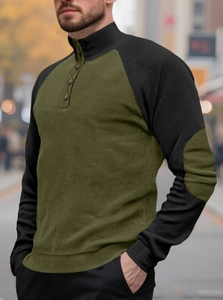 Close-up of olive green corduroy hoodie with button collar and textured knit detail