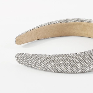 Macro shot of silver rhinestone headband detail with soft beige anti-slip velvet lining