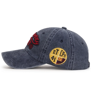 Vintage washed grey baseball cap with embroidery badges and curved brim on white background