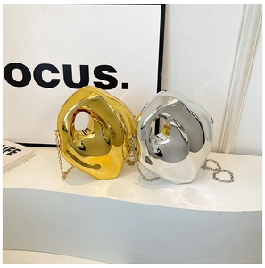 Artistic display of gold and silver acrylic box bags with irregular circular metal finish