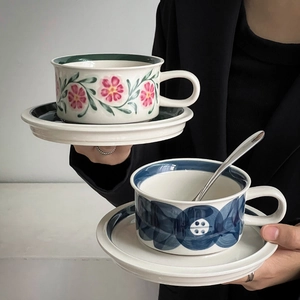 Detail of vintage hand-painted ceramic coffee cup sets with floral and blue patterns