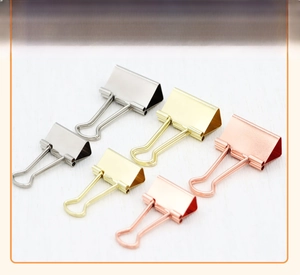 Detail view of premium metal binder clips in silver, gold, and rose gold finishes