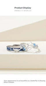 Detail view of whale and butterfly couple rings featuring blue enamel and zircon stones