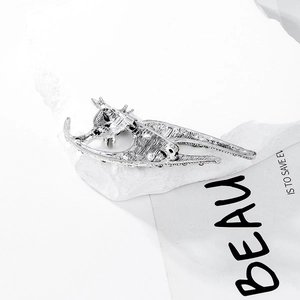 Vintage silver cat brooch with deer horn design and yellow gemstone accents on stone
