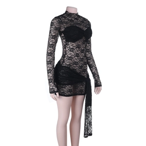 Close-up of black lace high-neck dress with sheer texture and elegant waist ribbon detail