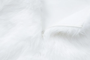 Detail shot of the back hidden zipper on a white plush faux fur evening party dress
