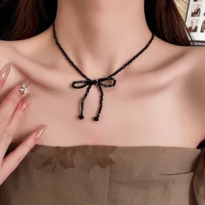 French style black beaded necklace with a bow pendant and elegant crystal pearl accents