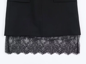 Detail of the black mini dress showing the intricate lace hemline and premium fabric