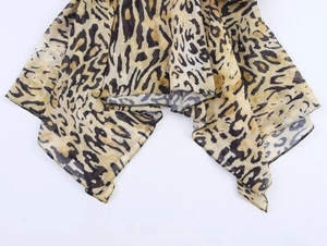 Detailed close-up of leopard print chiffon hem with asymmetrical cut and precise stitching