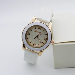 Detail of rose gold quartz watch with white leather croc strap and champagne dial