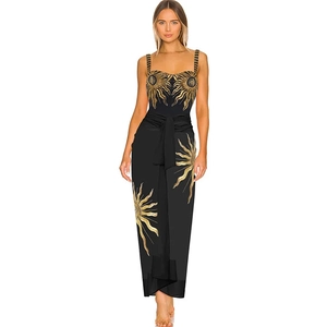 Close-up of intricate golden sunflower embroidery on a black one-piece swimsuit fabric