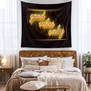 Detail of black tapestry with yellow neon good vibes only text in a modern bedroom