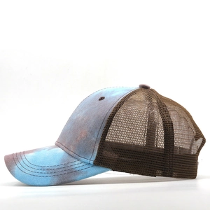 Detail of vintage tie-dye pattern on breathable trucker hat with brown mesh back panel