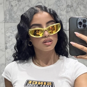 Steampunk futuristic Y2K sunglasses with yellow frame and reflective cat-eye lenses