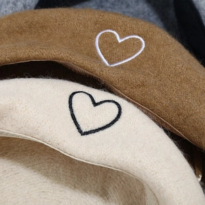 Brown and cream wool beret hats with minimalist heart embroidery and warm fuzzy texture