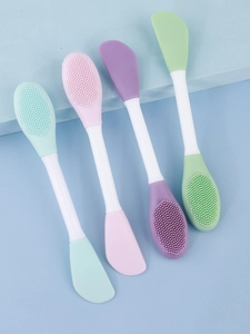 Set of four colorful dual-sided silicone face brushes for mask application and cleaning