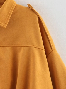 Detail of ginger suede jacket showing shoulder straps and fine double-stitched seams